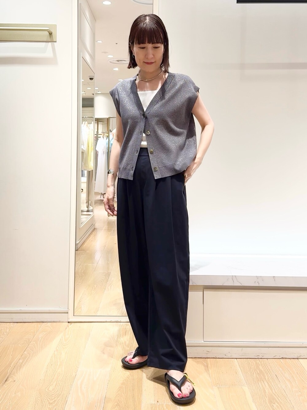 ブラック系のその他パンツ、ブラック系のサンダル、グレー系のベストを着用したレディースの夏コーディネートの6枚目の写真