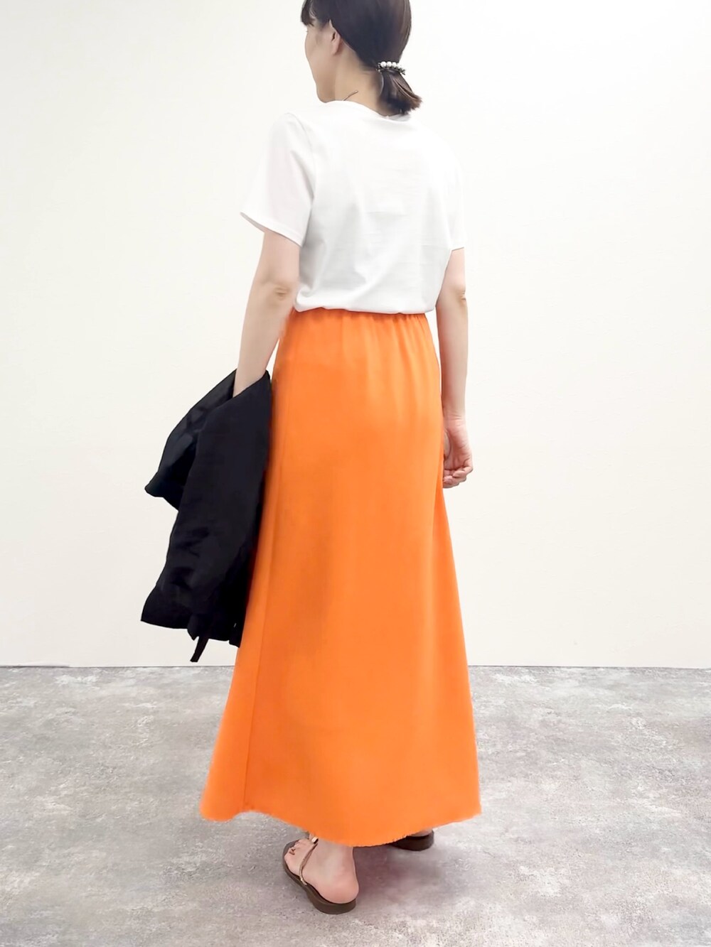 ホワイト系のTシャツ/カットソー、オレンジ系のスカート、ブラウン系のサンダルを着用したレディースの夏コーディネートの4枚目の写真
