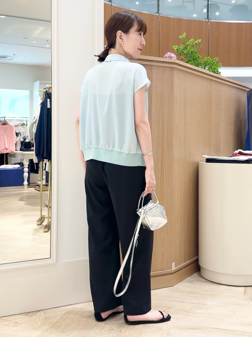シルバー系のショルダーバッグ、ブラック系のその他パンツ、グリーン系のシャツ/ブラウスを着用したレディースの夏コーディネートの7枚目の写真