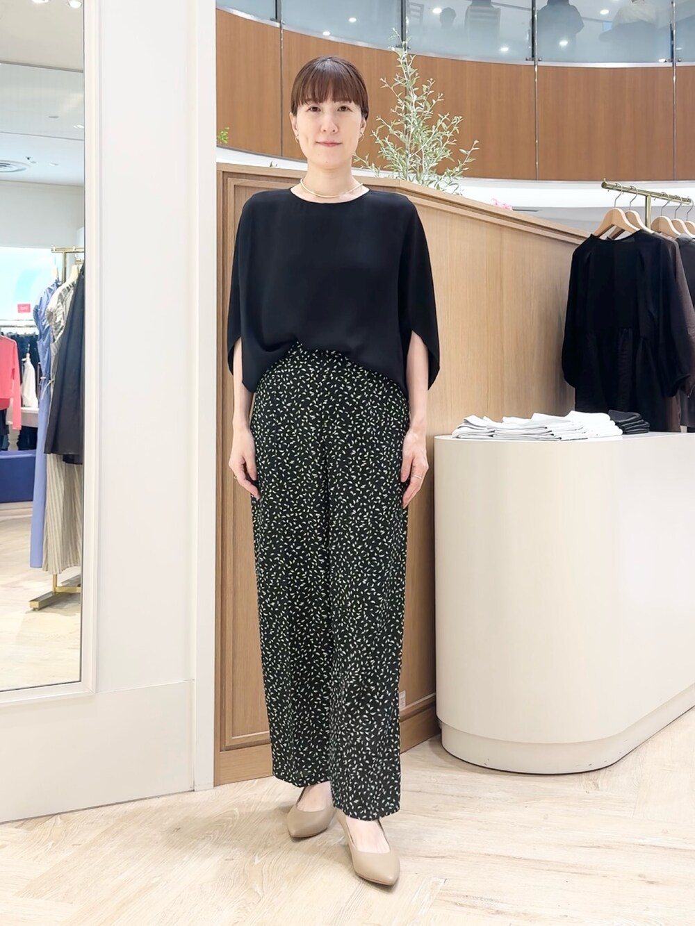 ブラック系のシャツ/ブラウス、ブラック系のその他パンツ、シルバー系のネックレスを着用したレディースの夏コーディネートの7枚目の写真