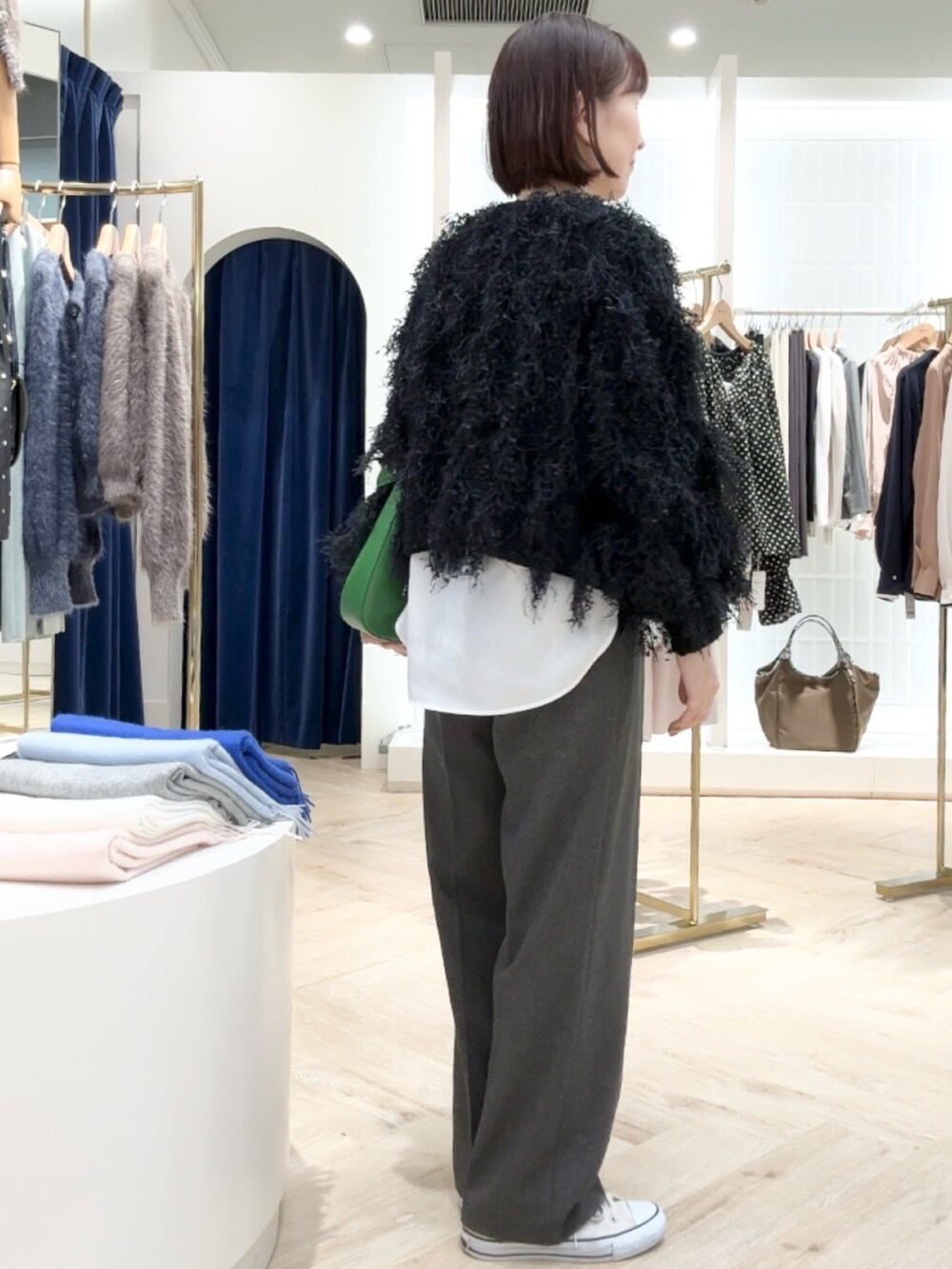 グレー系のその他パンツ、ホワイト系のシャツ/ブラウス、ブラック系のニット/セーターを着用したレディースの秋コーディネートの7枚目の写真