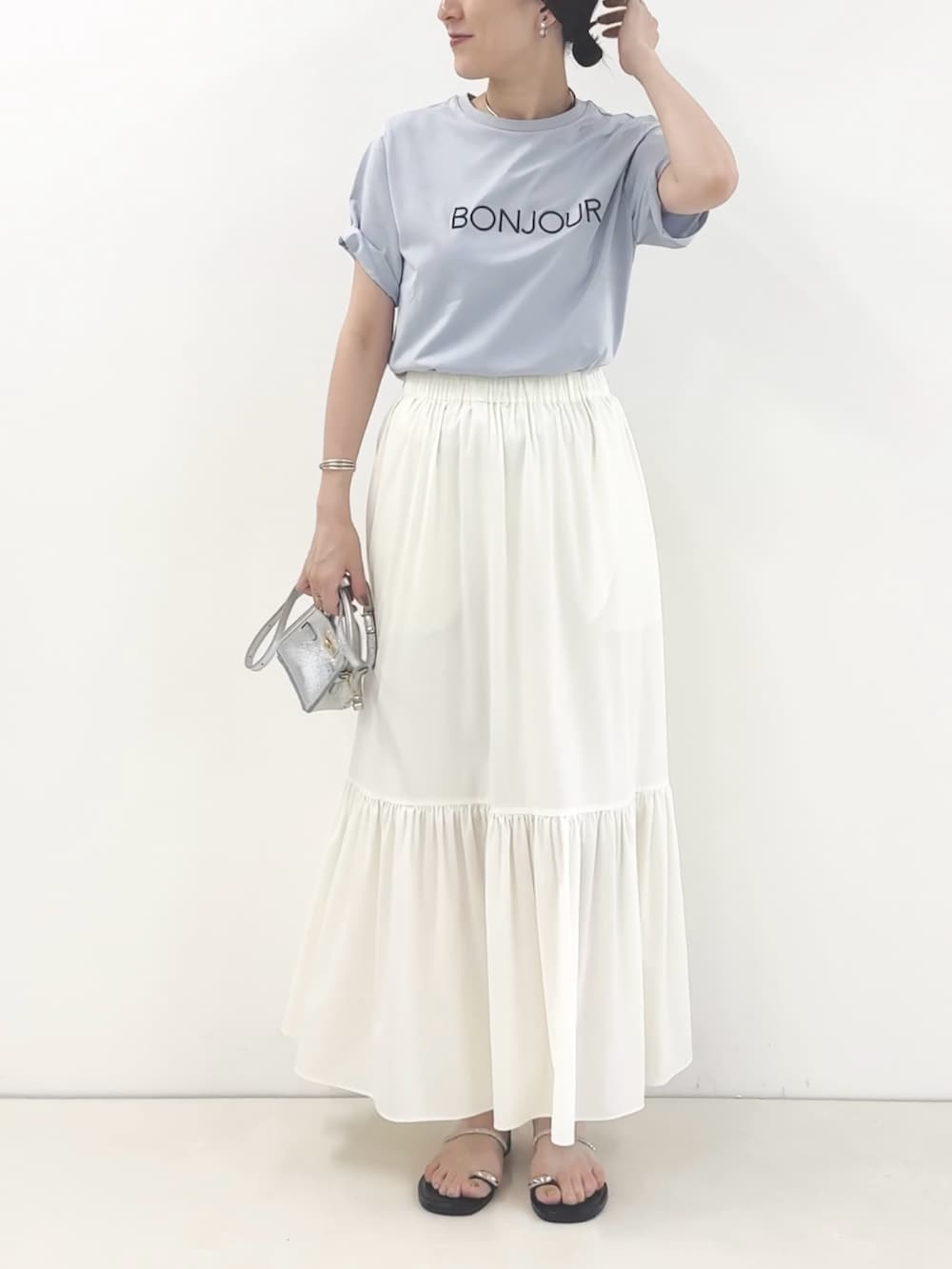 ホワイト系のスカート、シルバー系のサンダル、ブルー系のTシャツ/カットソーを着用したレディースの夏コーディネートの7枚目の写真