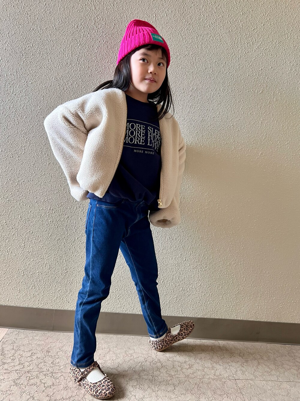 ブルー系のスウェット、ブルー系のデニムパンツ、ブラウン系のバレエシューズを着用したキッズの冬コーディネートの2枚目の写真