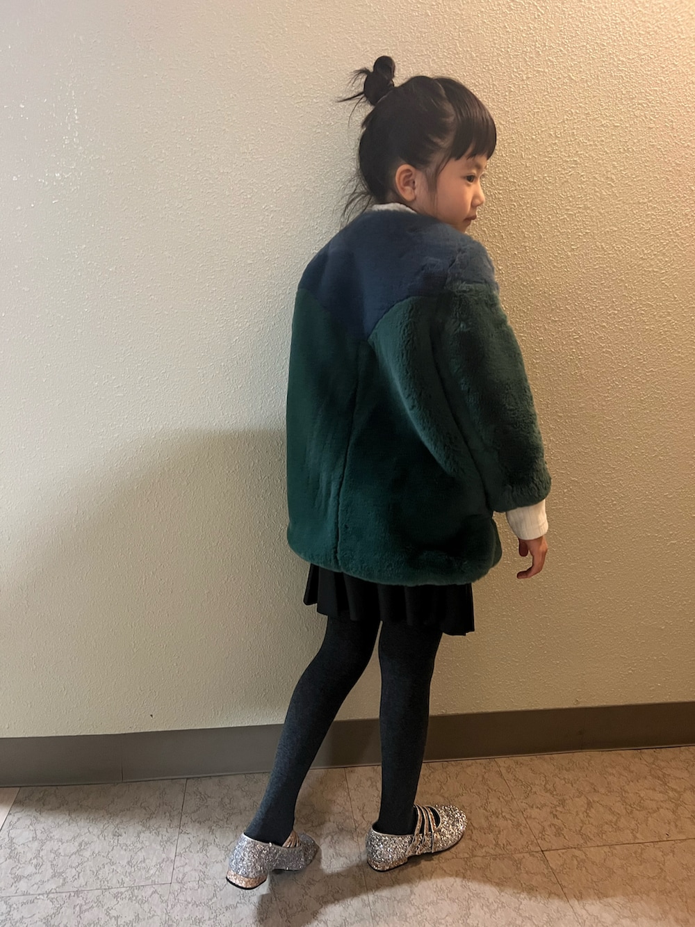 「クリスマスに着たい服、キッズファッション、女の子コーデ、モード、ファーコート、ミニスカート、おんなのこ、小学生、おだんごヘアー、もこもこ、冬コーデ、レザー、スカート、バレエシューズ」｜「venitのアイテム（ムートンコート、グリーン系）」を使った、pecocoさん（キッズ・120cm）の冬コーディネートの3枚目の写真