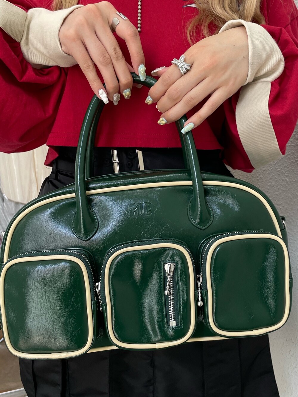 レッド系のTシャツ/カットソー、ブラック系のその他パンツ、グリーン系のボストンバッグを着用したレディースの夏コーディネートの8枚目の写真