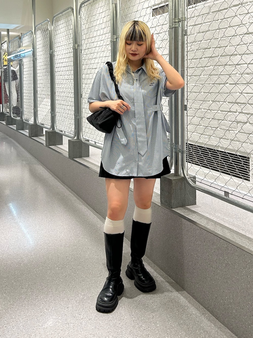 ブルー系のシャツ/ブラウス、ブラック系のスカート、ブラック系のショルダーバッグを着用したレディースの夏コーディネートの2枚目の写真