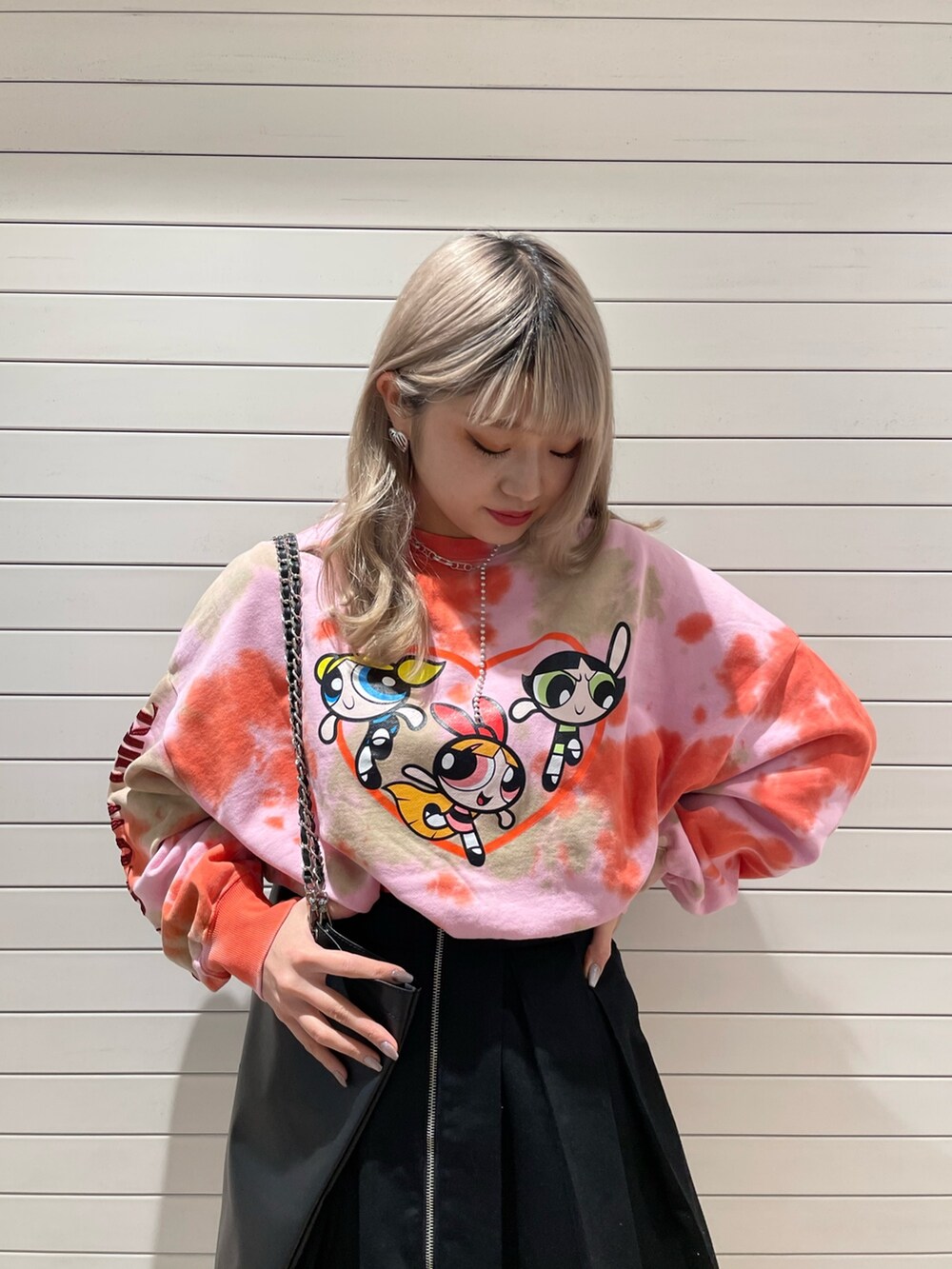 ピンク系のスウェット、ブラック系のその他パンツ、ブラック系のトートバッグを着用したレディースの冬コーディネートの3枚目の写真