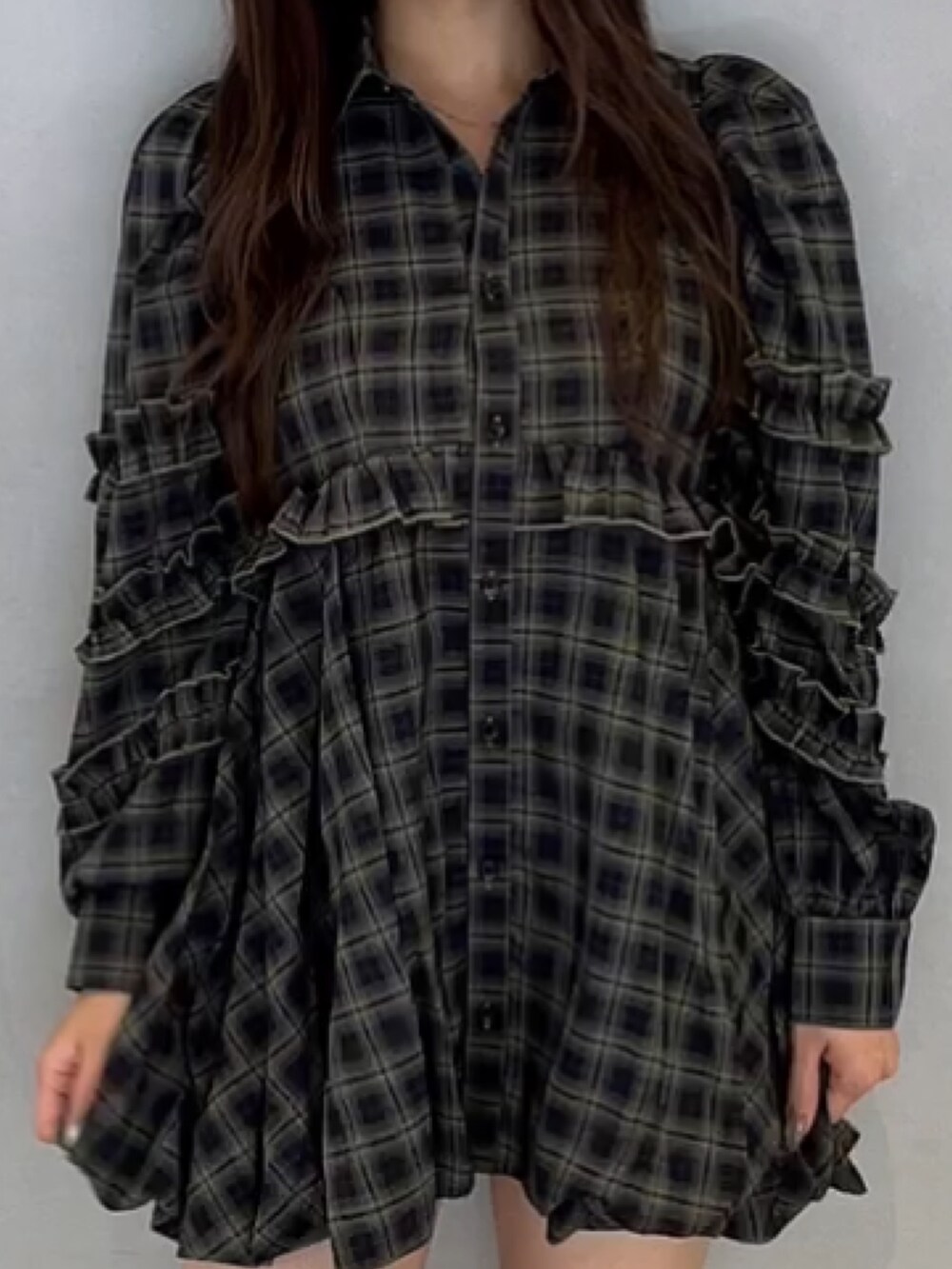 グリーン系のワンピース、ブラック系のブーツを着用したレディースの秋コーディネートの5枚目の写真