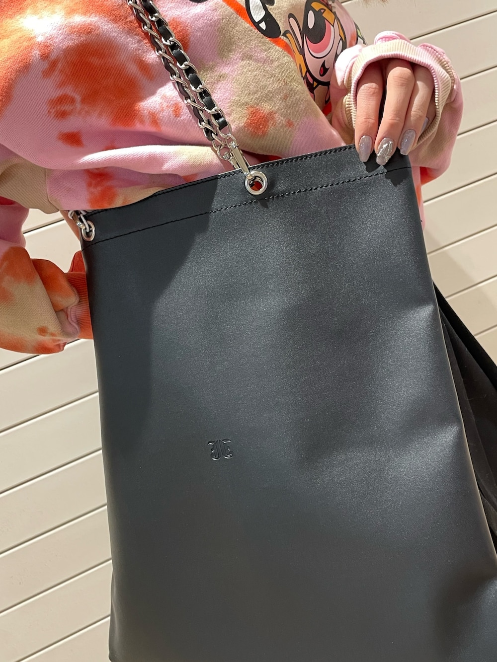 ピンク系のスウェット、ブラック系のその他パンツ、ブラック系のトートバッグを着用したレディースの冬コーディネートの8枚目の写真