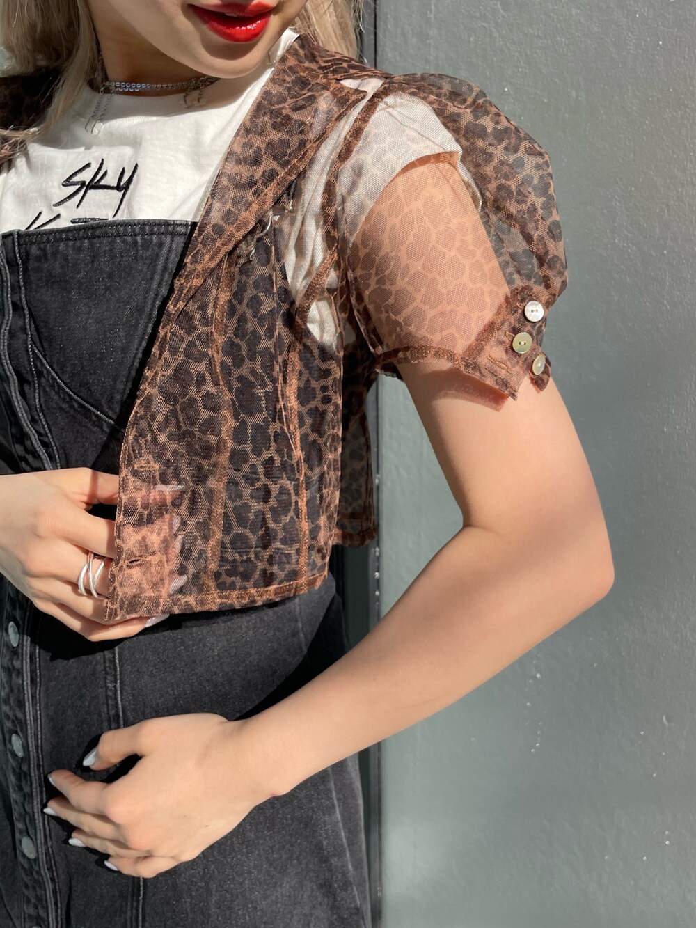 ブラック系のジャンパースカート、ホワイト系のタンクトップ、ブラウン系のシャツ/ブラウスを着用したレディースの春コーディネートの7枚目の写真