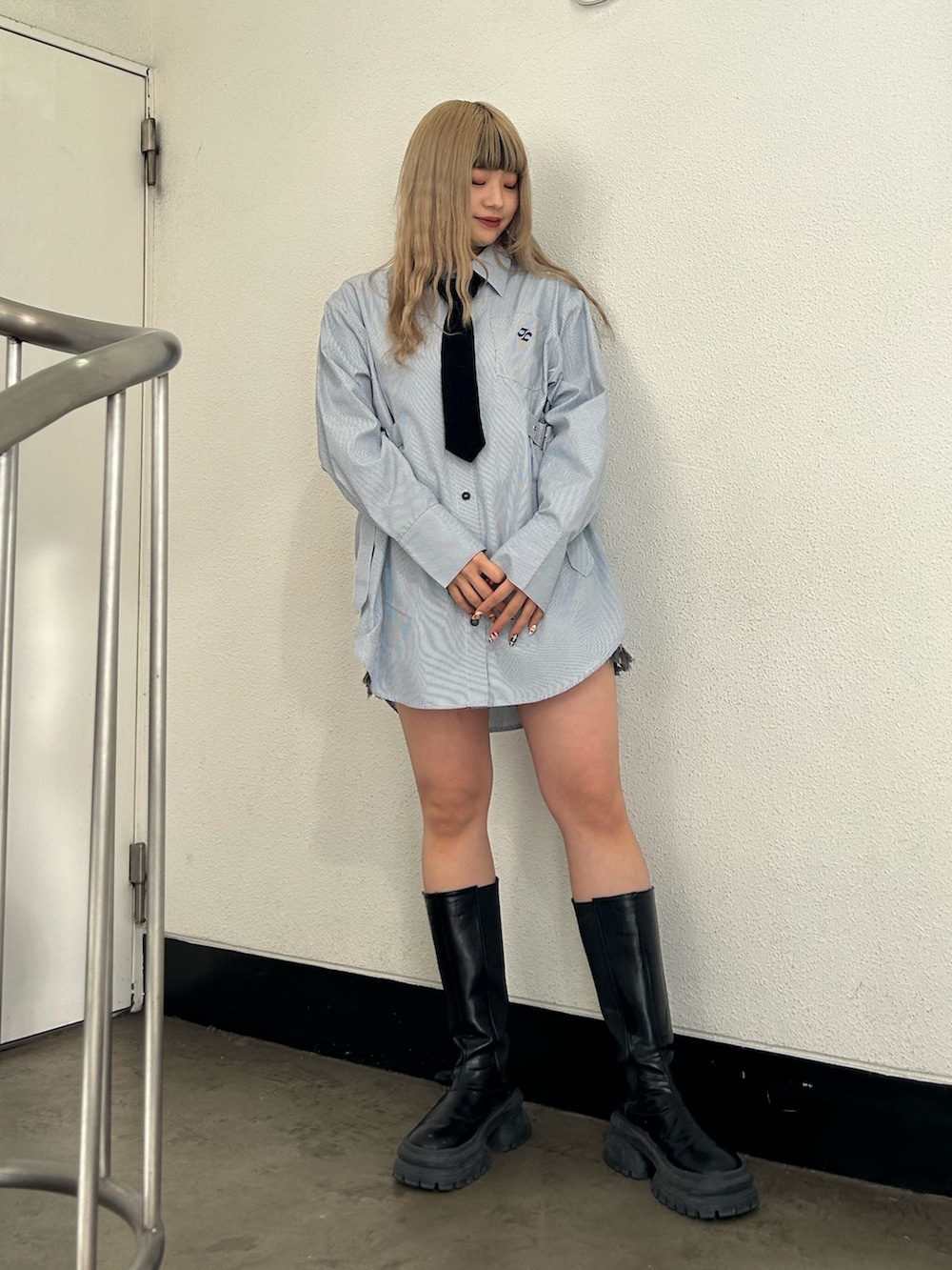 ブルー系のシャツ/ブラウス、ブラック系のデニムパンツ、ブラック系のブーツを着用したレディースの冬コーディネートの2枚目の写真