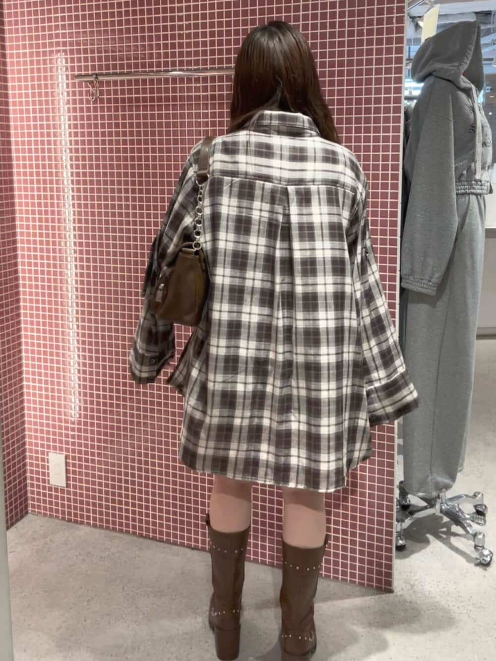 ブラウン系のシャツ/ブラウス、ブラウン系のハンドバッグ、ブラウン系のブーツを着用したレディースの春コーディネートの4枚目の写真