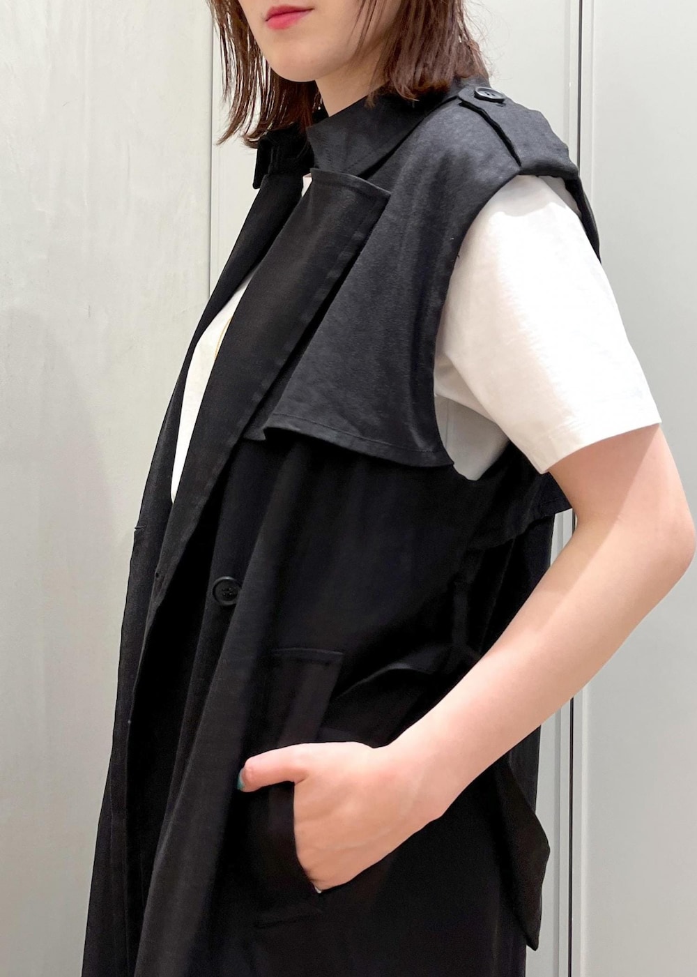 シルバー系のサンダル、ブラック系のハンドバッグ、ブルー系のデニムパンツを着用したレディースの夏コーディネートの5枚目の写真