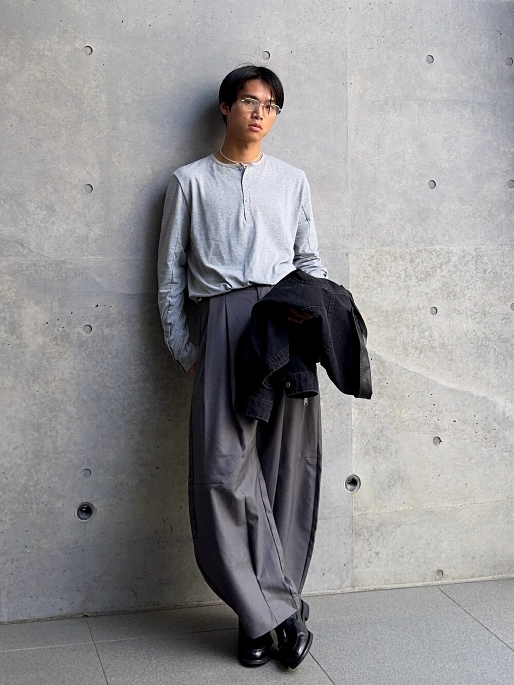 グレー系のTシャツ/カットソー、ブラック系のデニムジャケット、ブラック系のローファーを着用したメンズの春コーディネートの5枚目の写真
