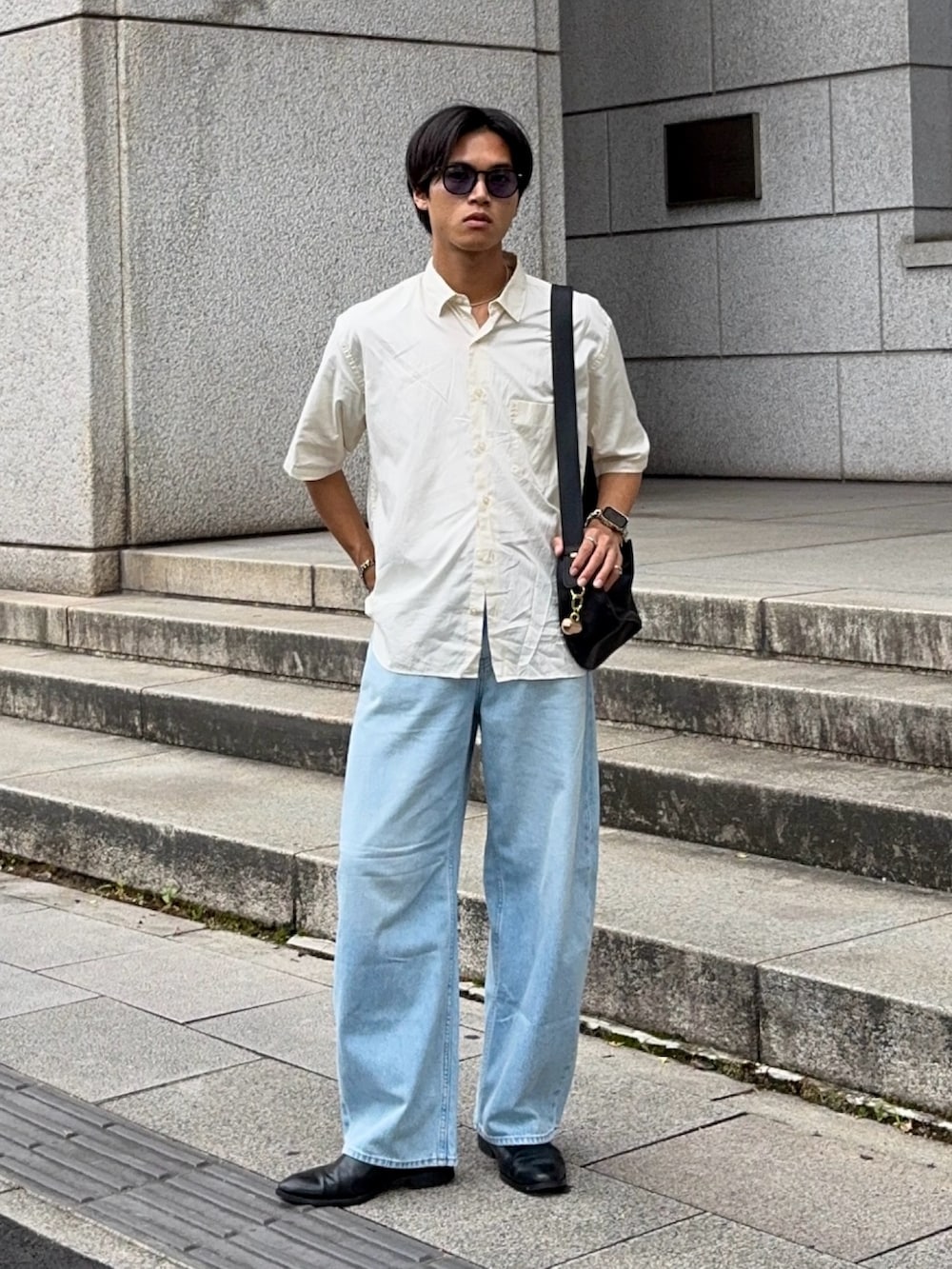 ブラック系のハンドバッグ、ベージュ系のシャツ/ブラウス、ブルー系のデニムパンツを着用したメンズの夏コーディネートの5枚目の写真