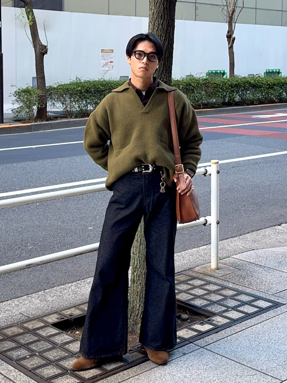 グリーン系のニット/セーター、ブラウン系のシャツ/ブラウス、ブラック系のデニムパンツを着用したメンズの冬コーディネートの3枚目の写真