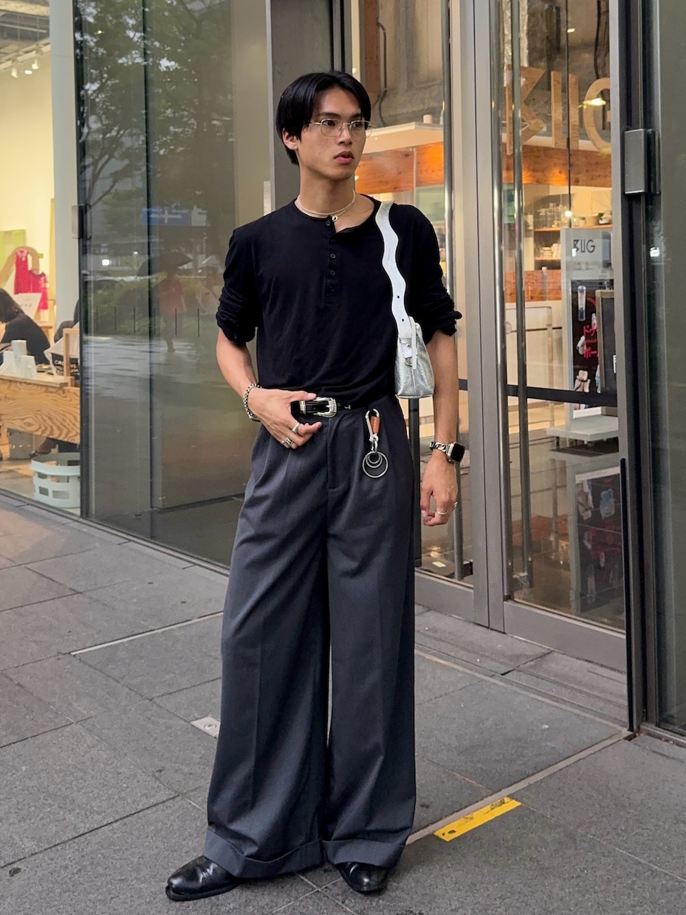 ブラック系のTシャツ/カットソー、グレー系のスラックス、シルバー系のショルダーバッグを着用したメンズの夏コーディネートの3枚目の写真
