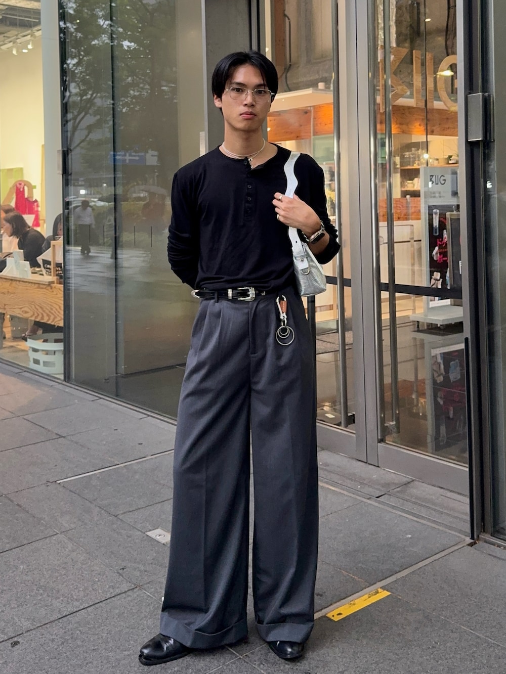 ブラック系のTシャツ/カットソー、グレー系のスラックス、シルバー系のショルダーバッグを着用したメンズの夏コーディネートの5枚目の写真