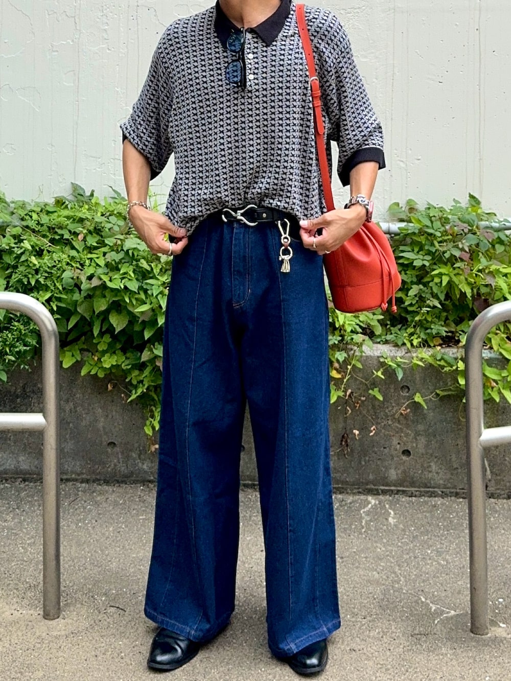 ブルー系のデニムパンツ、ブラック系のブーツ、グレー系のポロシャツを着用したメンズの夏コーディネートの4枚目の写真
