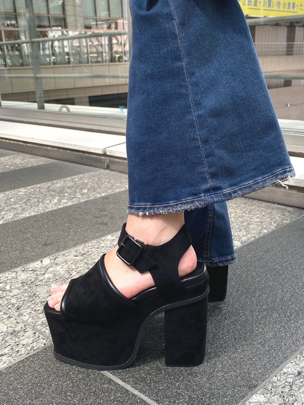 ホワイト系のニット/セーター、ブルー系のデニムパンツ、ブラック系のサンダルを着用したレディースの夏コーディネートの5枚目の写真