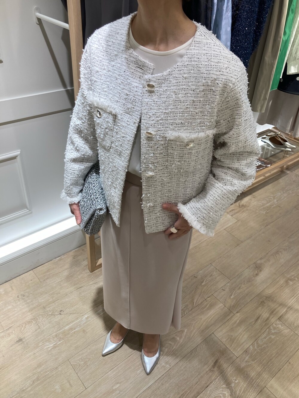 ホワイト系のノーカラージャケット、ベージュ系のスカート、ホワイト系のシャツ/ブラウスを着用したレディースの冬コーディネートの4枚目の写真
