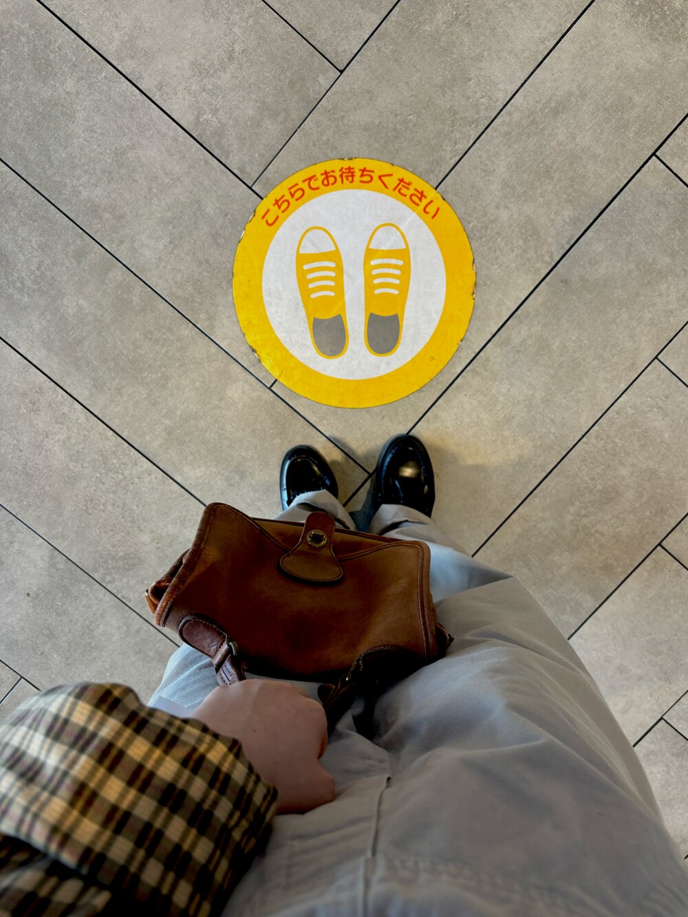 ブラウン系のバッグ、ブラック系のローファー、ベージュ系のシャツ/ブラウスを着用したレディースの春コーディネートの2枚目の写真