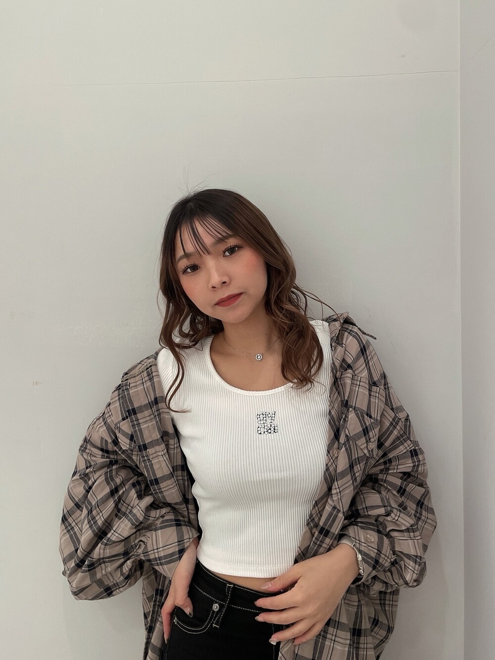 ベージュ系のシャツ/ブラウス、ホワイト系のTシャツ/カットソー、ブラック系のデニムパンツを着用したレディースの春コーディネートの4枚目の写真