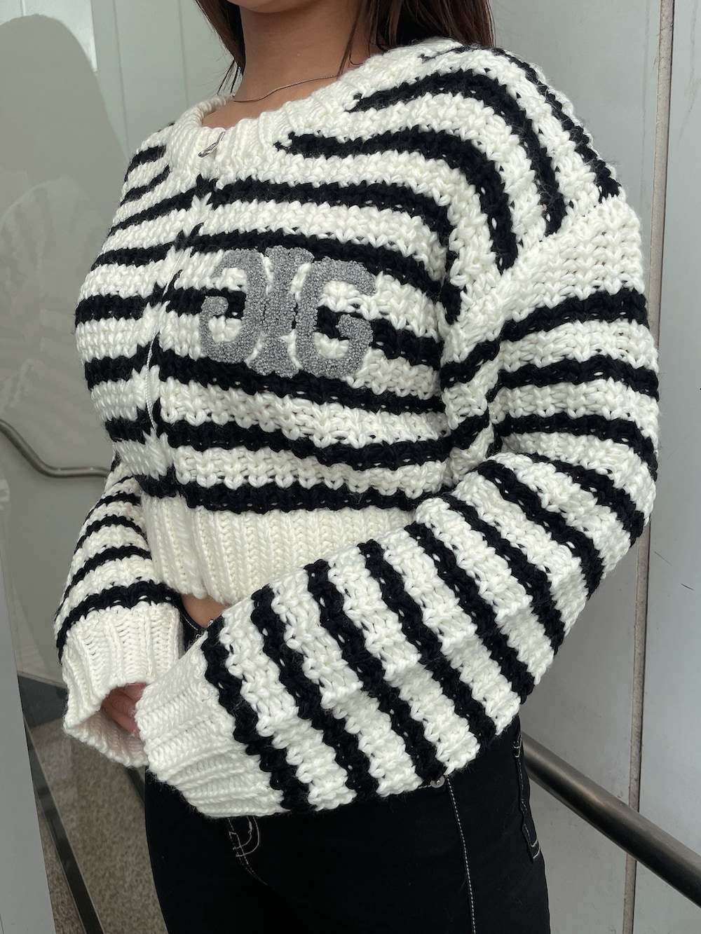 その他のカーディガン/ボレロ、ブラック系のデニムパンツ、ブラック系のブーツを着用したレディースの秋コーディネートの7枚目の写真
