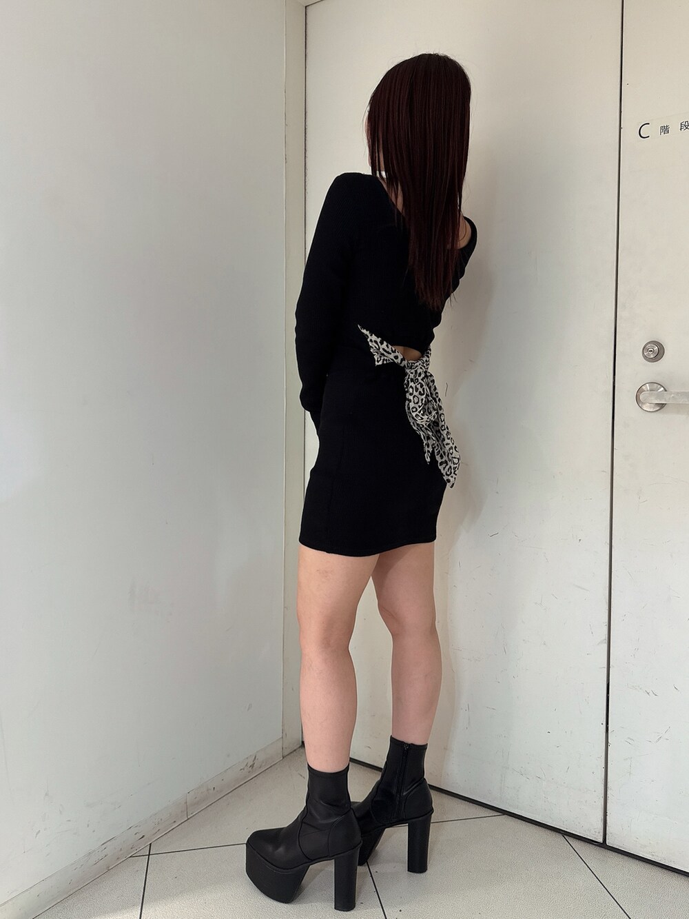 ブラック系のワンピース、ブラック系のブーツを着用したレディースの夏コーディネートの2枚目の写真