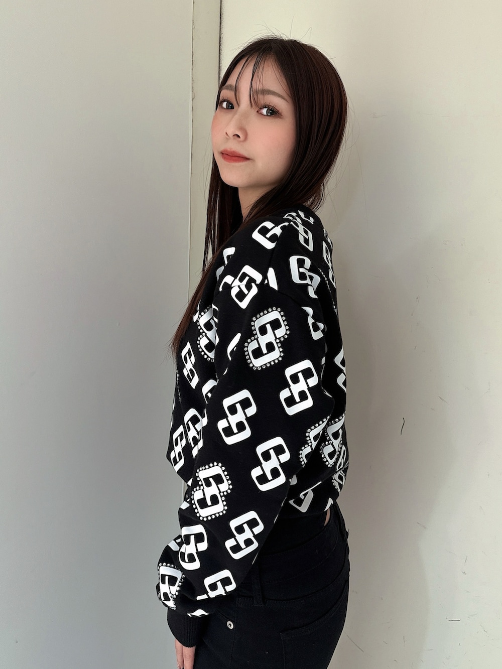 ブラック系のデニムパンツ、ブラック系のブーツ、ブラック系のスウェットを着用したレディースの冬コーディネートの5枚目の写真