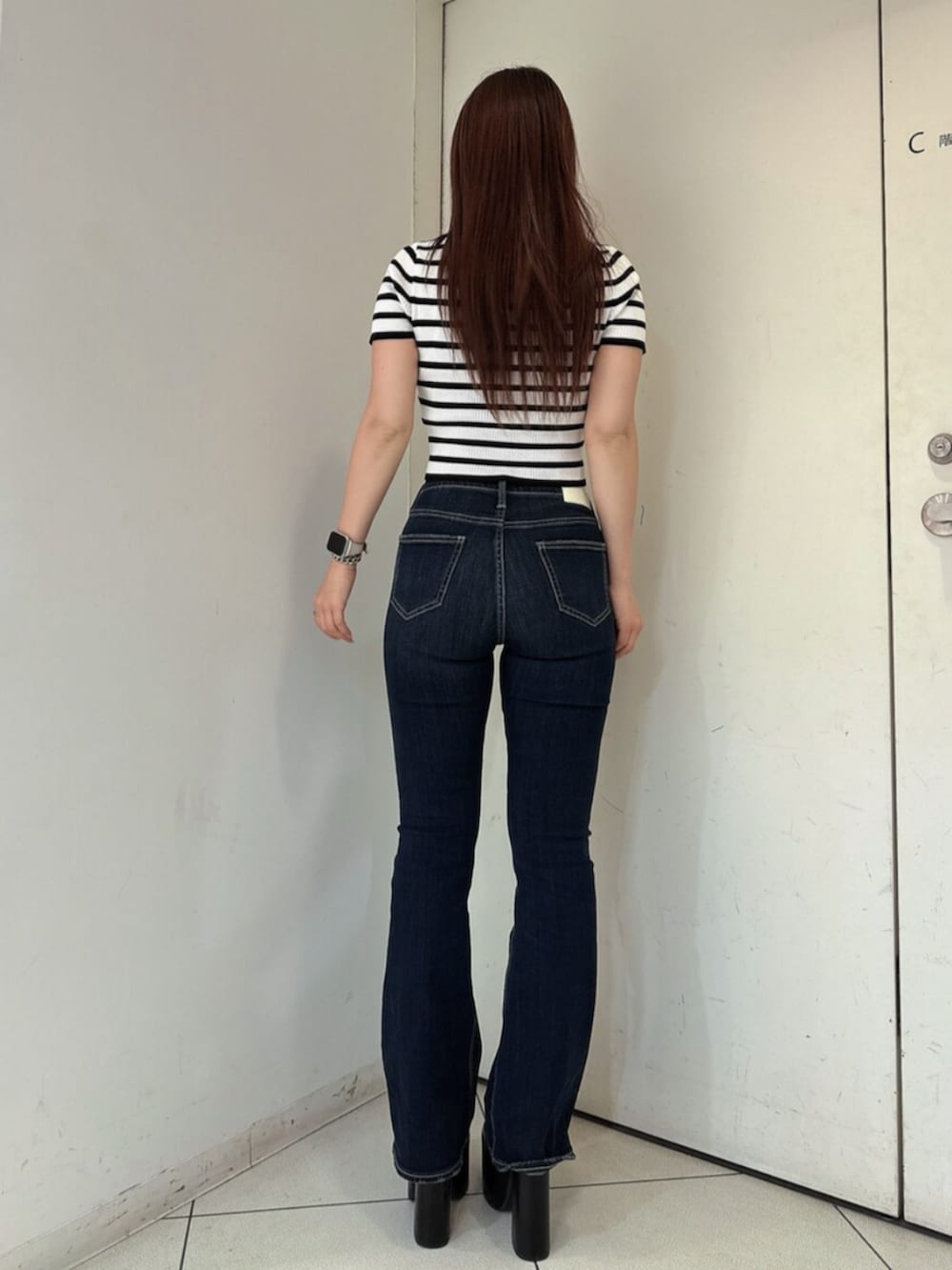 ブルー系のデニムパンツ、ブラック系のサンダル、その他のニット/セーターを着用したレディースの春コーディネートの3枚目の写真