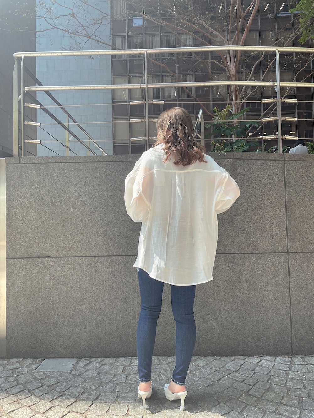 ブルー系のTシャツ/カットソー、ホワイト系のチューブトップ、ブルー系のデニムパンツを着用したレディースの春コーディネートの2枚目の写真