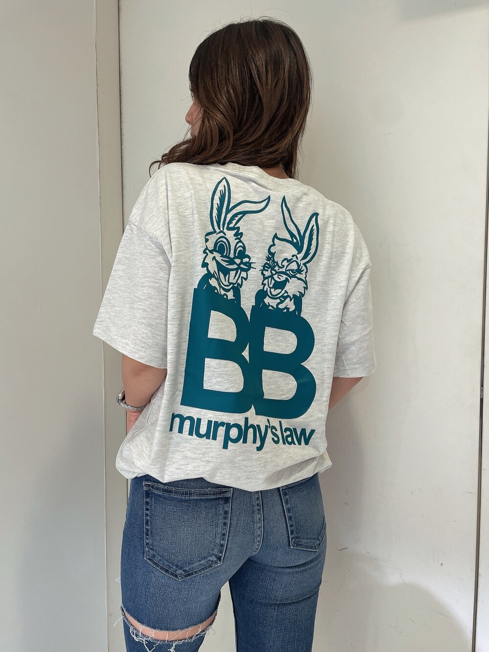 グレー系のTシャツ/カットソー、ブルー系のデニムパンツ、ホワイト系のサンダルを着用したレディースの夏コーディネートの5枚目の写真