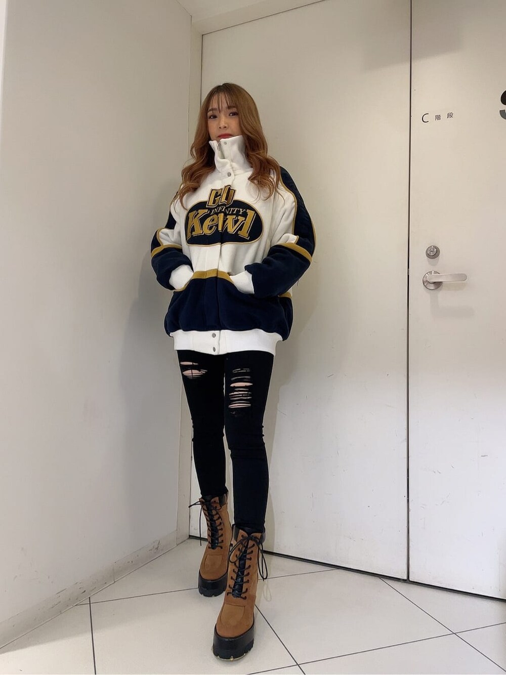 ブラック系のデニムパンツ、ブラック系のデニムパンツ、ホワイト系のブルゾンを着用したレディースの秋コーディネートの2枚目の写真