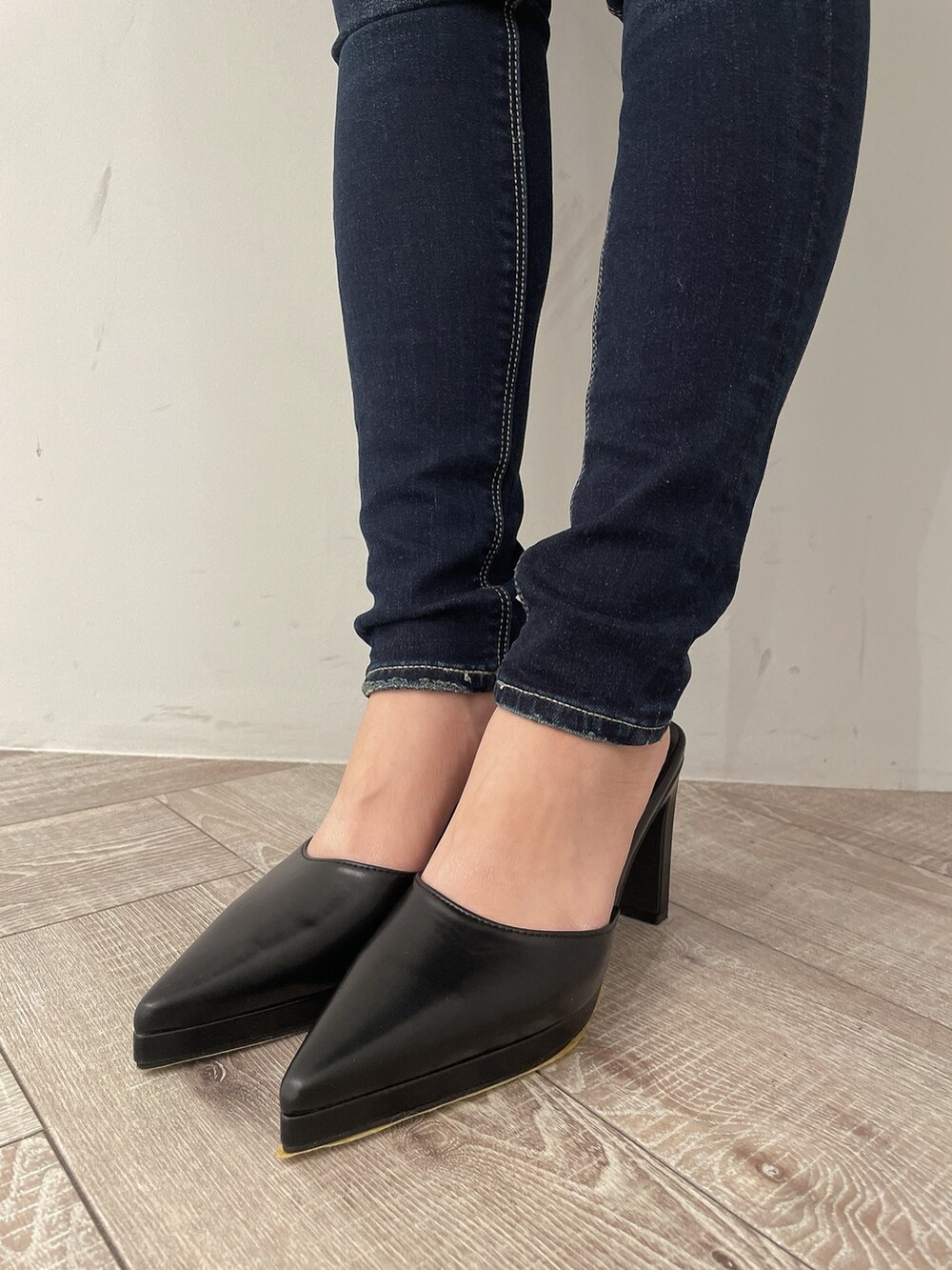 ブラック系のニット/セーター、ブルー系のデニムパンツ、ブラック系のパンプスを着用したレディースの冬コーディネートの7枚目の写真