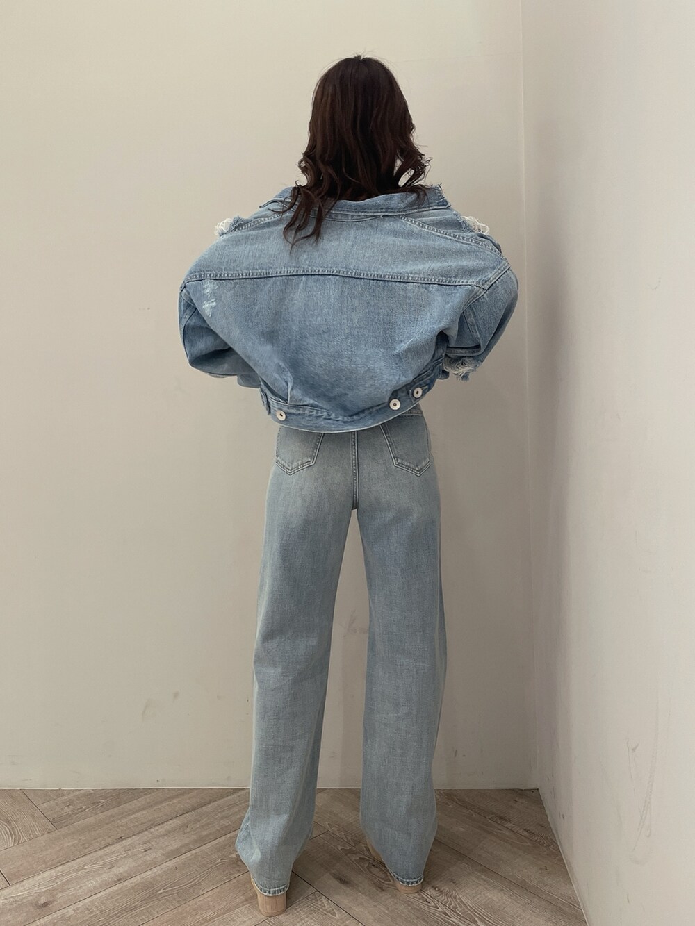 ホワイト系のサンダル、ブルー系のチューブトップ、ブルー系のデニムジャケットを着用したレディースの春コーディネートの3枚目の写真