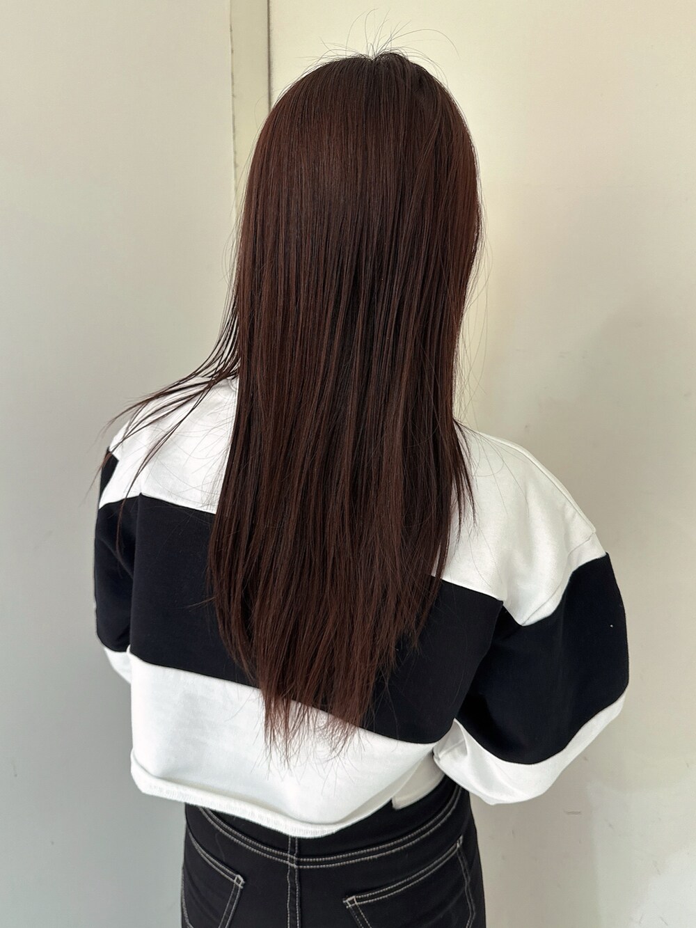 ブラック系のデニムパンツ、ブラック系のブーツ、ホワイト系のTシャツ/カットソーを着用したレディースの冬コーディネートの6枚目の写真
