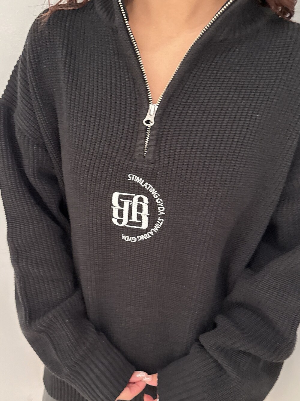 ブラック系のスカート、ブラック系のニット/セーター、ブラック系のブーツを着用したレディースの冬コーディネートの7枚目の写真