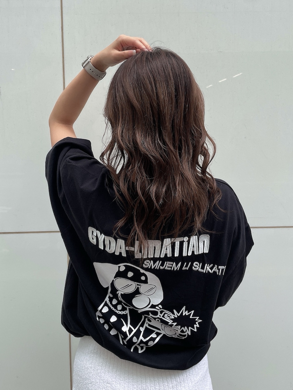 ブラック系のTシャツ/カットソー、ホワイト系のスカート、ホワイト系のサンダルを着用したレディースの春コーディネートの4枚目の写真