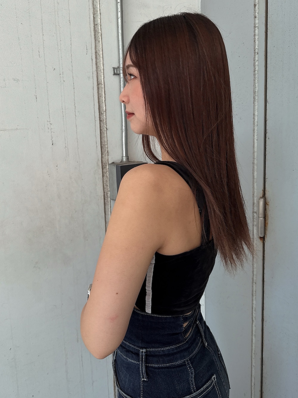 ブラック系のキャミソール、ブルー系のデニムスカート、ブラック系のサンダルを着用したレディースの夏コーディネートの5枚目の写真