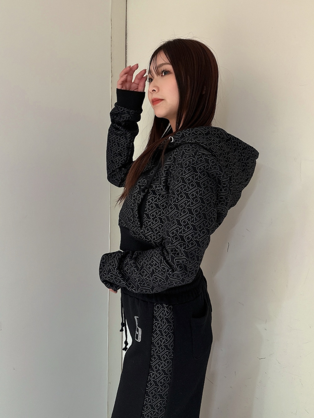 ブラック系のスウェットパンツ、ブラック系のパーカー、ブラック系のブーツを着用したレディースの冬コーディネートの5枚目の写真