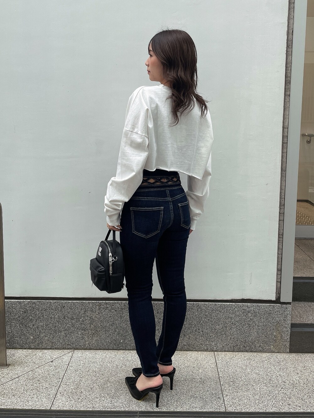 ホワイト系のTシャツ/カットソー、ブラック系のキャミソール、ブラック系のバックパック/リュックを着用したレディースの春コーディネートの2枚目の写真