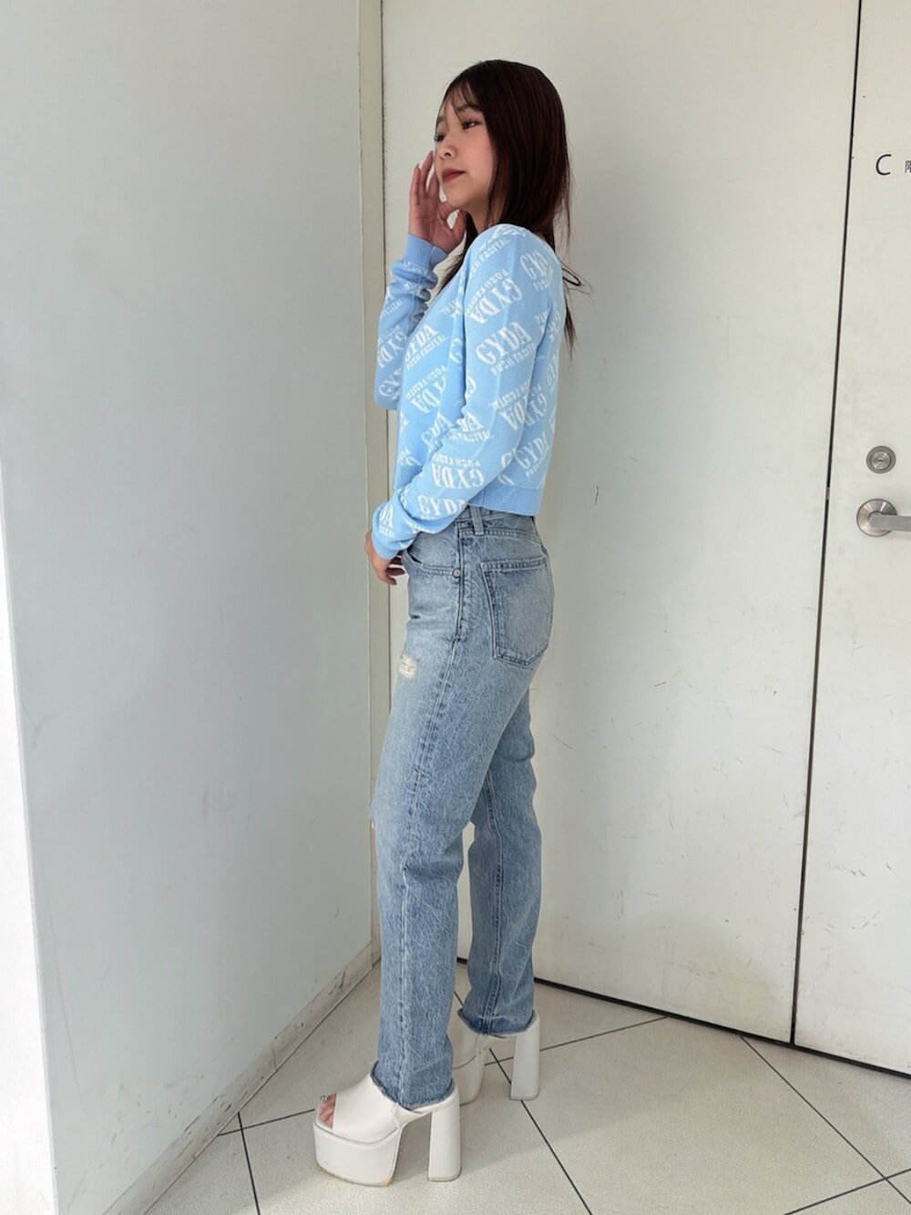 ブラック系のサンダル、ブルー系のデニムパンツ、ホワイト系のキャミソールを着用したレディースの夏コーディネートの2枚目の写真