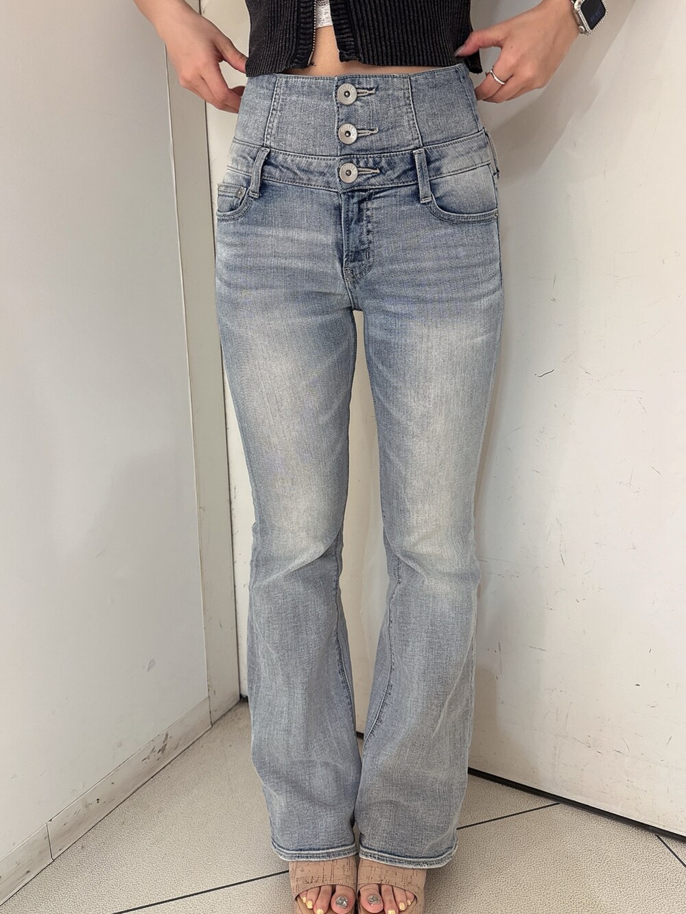 ブルー系のデニムパンツ、ブラック系のニット/セーター、ホワイト系のサンダルを着用したレディースの春コーディネートの8枚目の写真