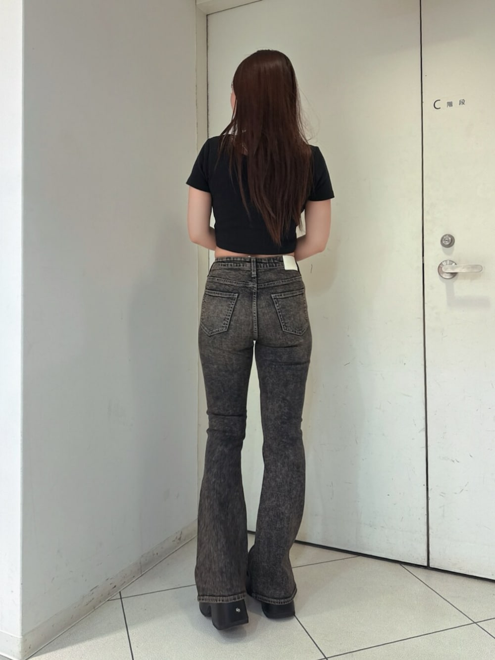 ブラック系のサンダル、ブルー系のデニムパンツ、ブラック系のTシャツ/カットソーを着用したレディースの夏コーディネートの3枚目の写真