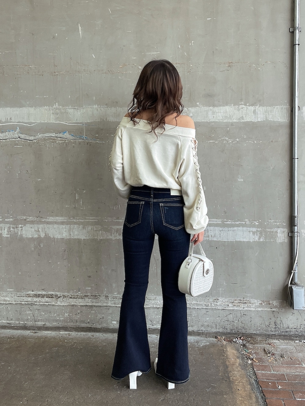 ホワイト系のスウェット、ホワイト系のハンドバッグ、ホワイト系のパンプスを着用したレディースの春コーディネートの4枚目の写真