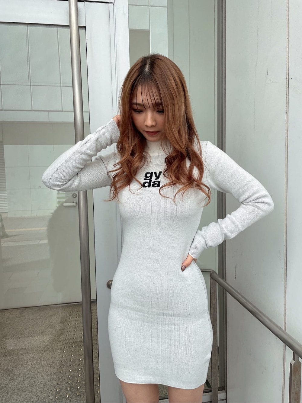 ブラック系のブーツ、グレー系のライダースジャケット、ホワイト系のワンピースを着用したレディースの秋コーディネートの6枚目の写真