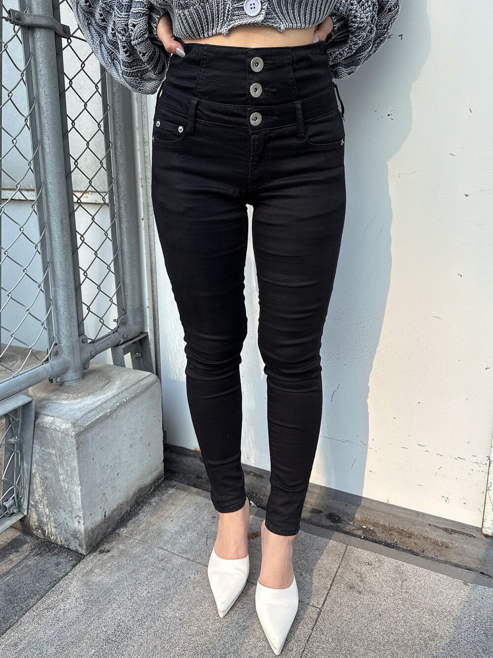 ブラック系のデニムパンツ、ブラック系のキャミソール、ホワイト系のカーディガン/ボレロを着用したレディースの春コーディネートの7枚目の写真