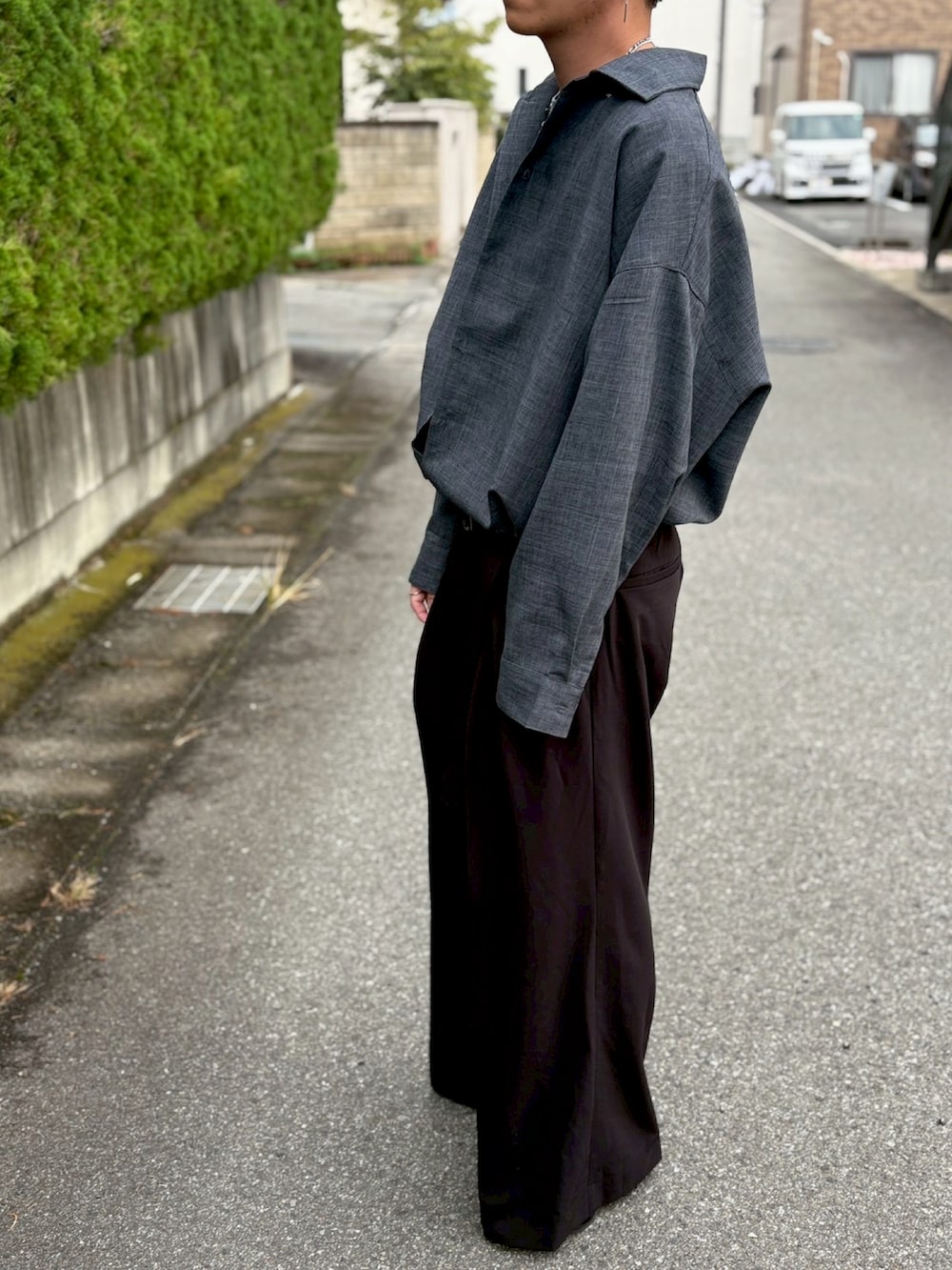 グレー系のシャツ/ブラウス、グレー系のTシャツ/カットソー、ブラック系のスラックスを着用したメンズの秋コーディネートの2枚目の写真