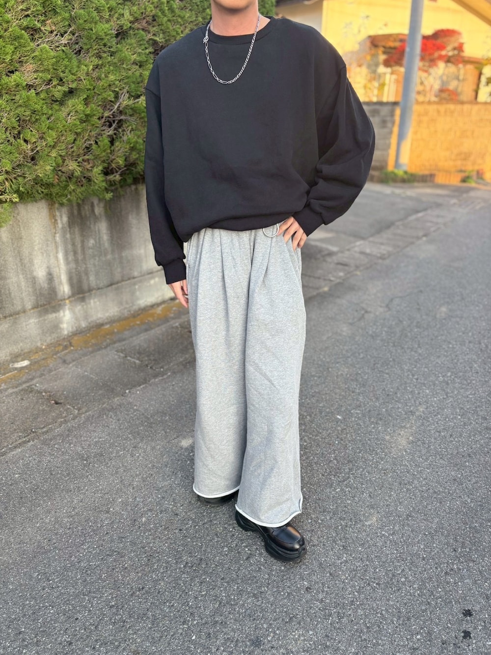 ブラック系のスウェット、グレー系のスウェットパンツ、ブラック系のスニーカーを着用したメンズの秋コーディネートの2枚目の写真